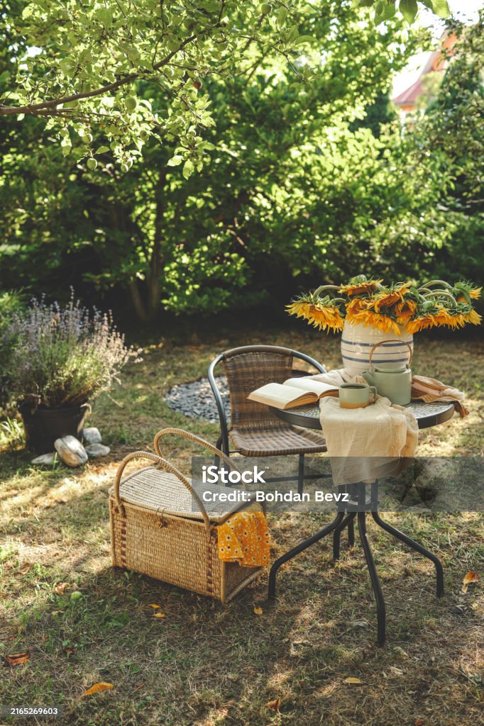 Summer morning in the garden. Book, sunflowers and tea, mood.